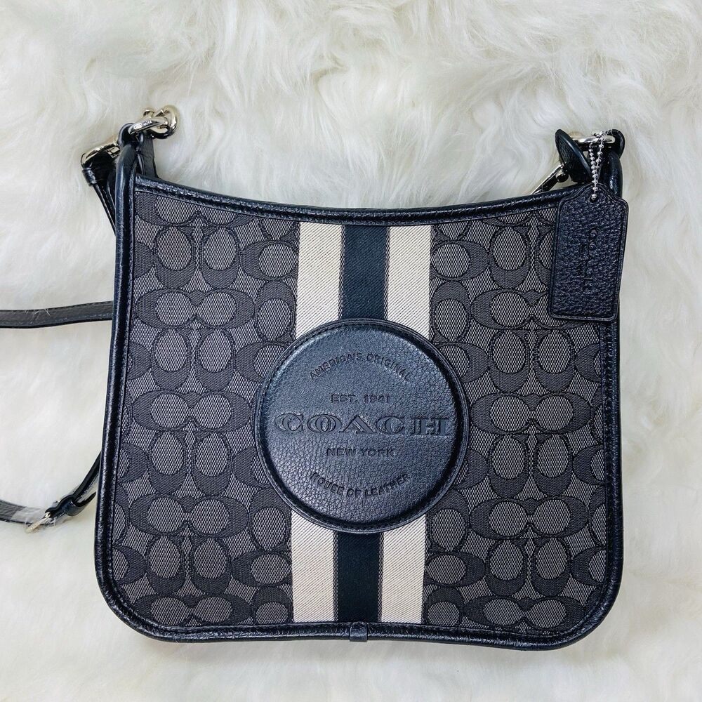 Coach Dempsey File Bag features a signature jacquard